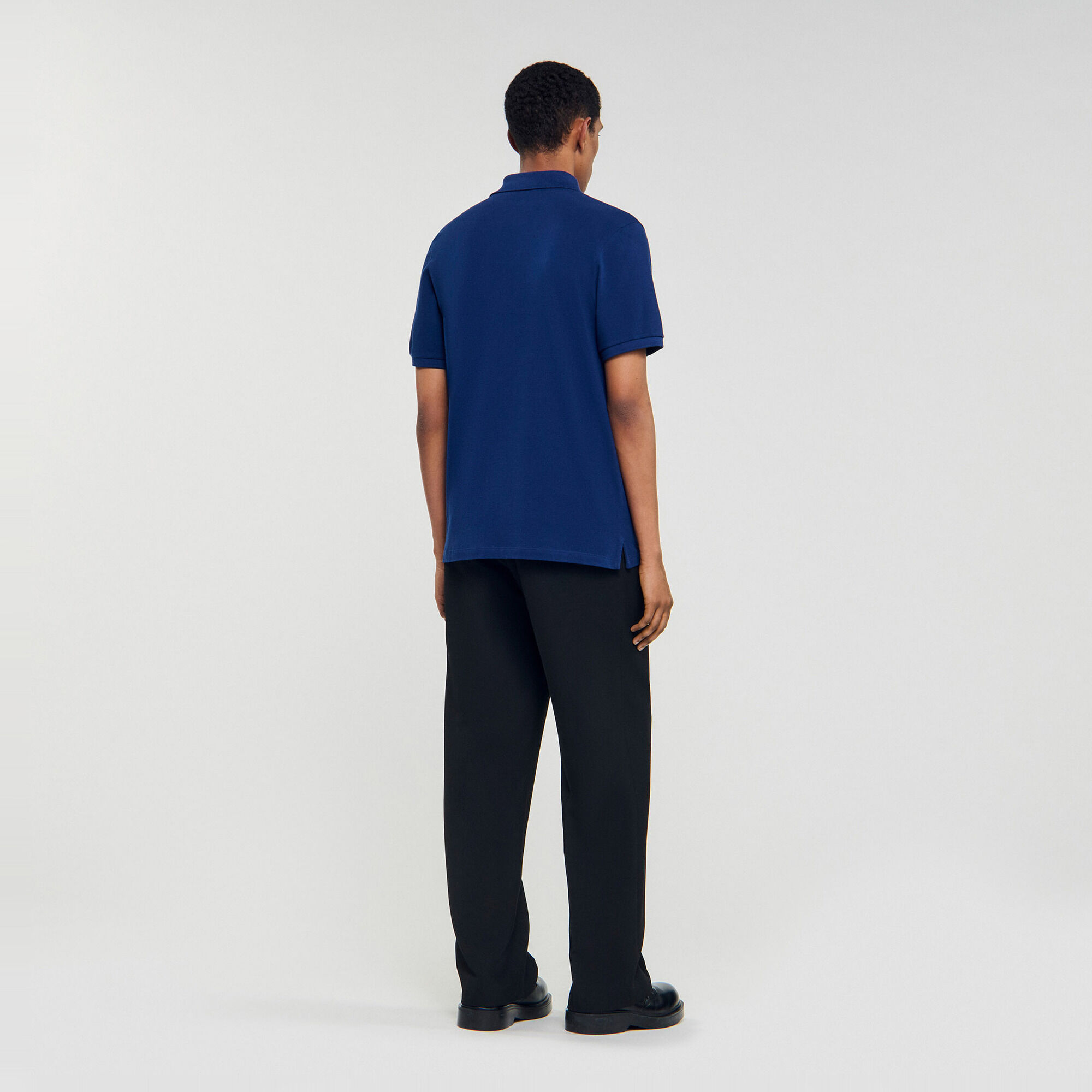 Polo shirt with leather logo - Men | Sandro