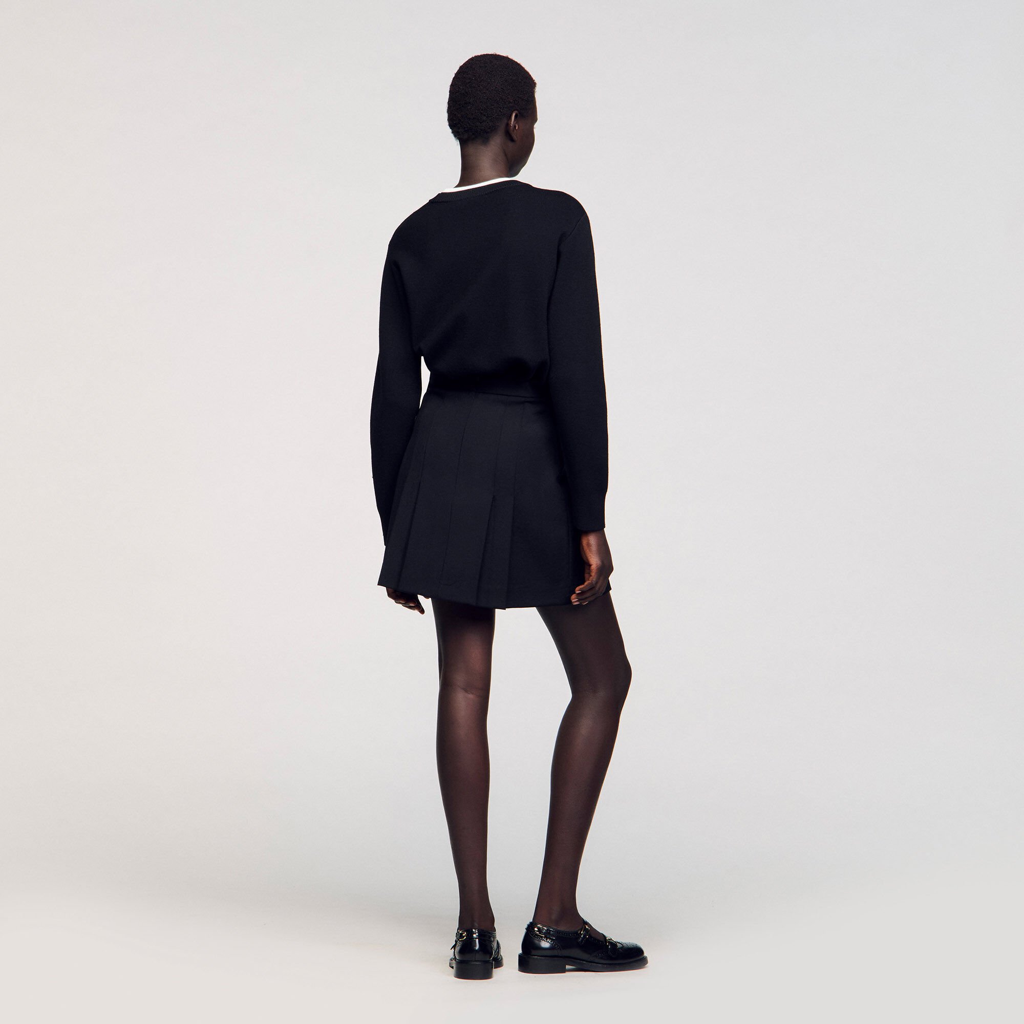 Short skirt with stitched pleats