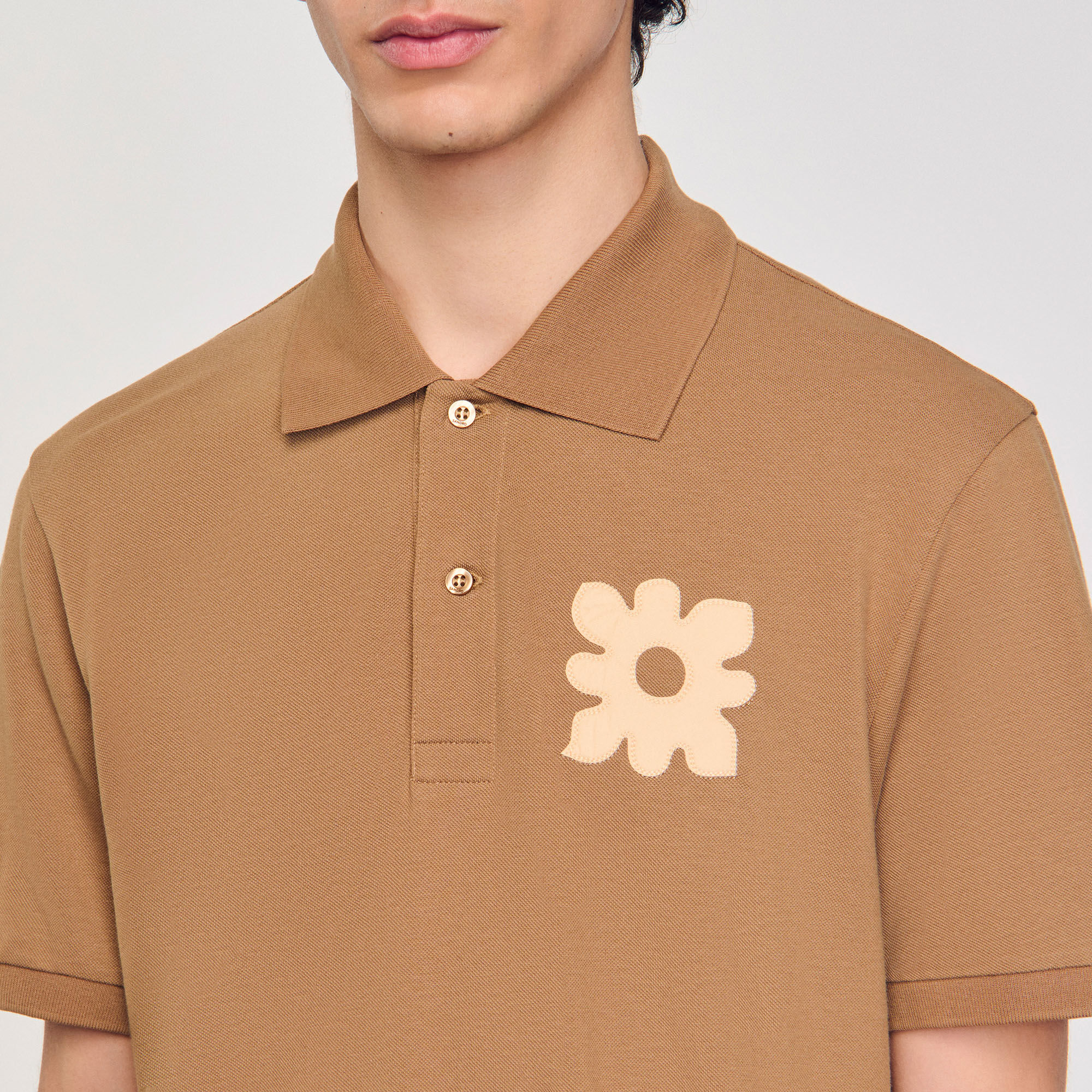 Polo shirt with flower patch