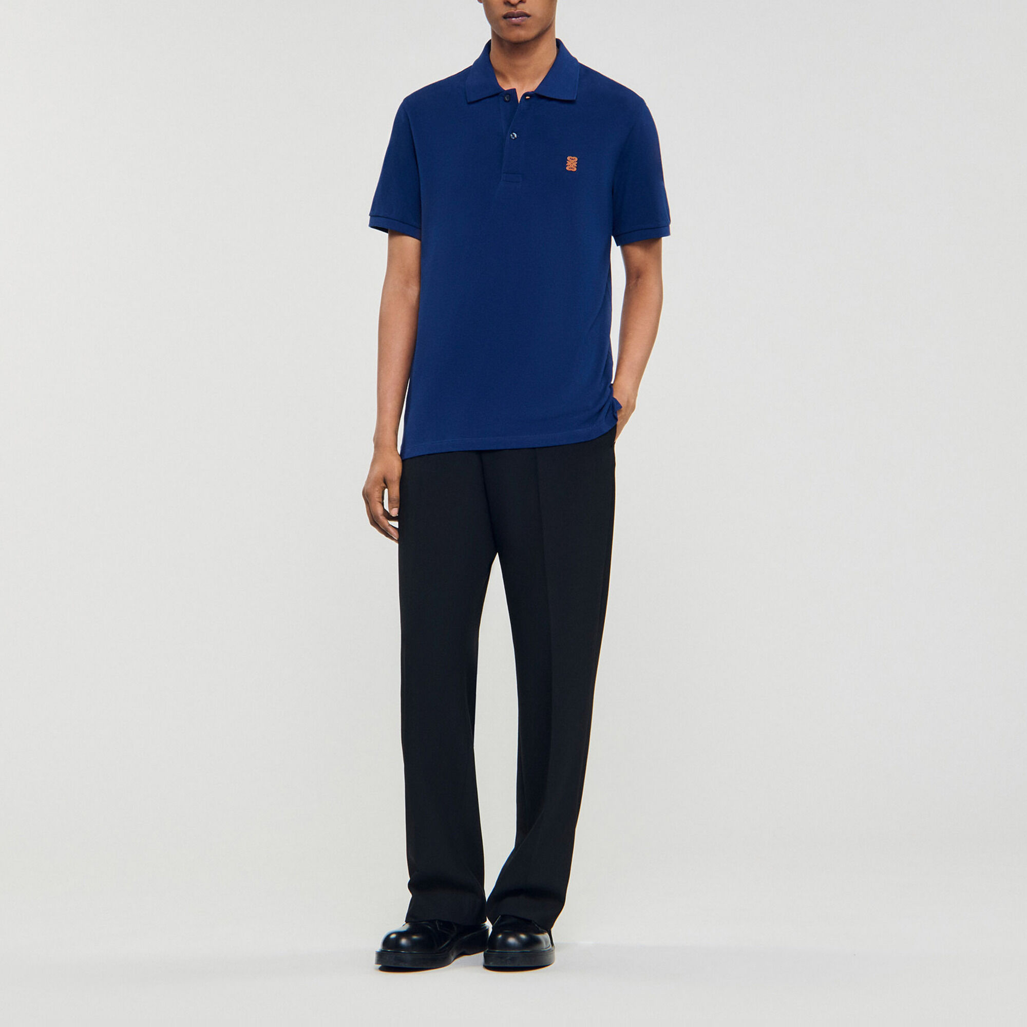 Polo shirt with leather logo - Men | Sandro