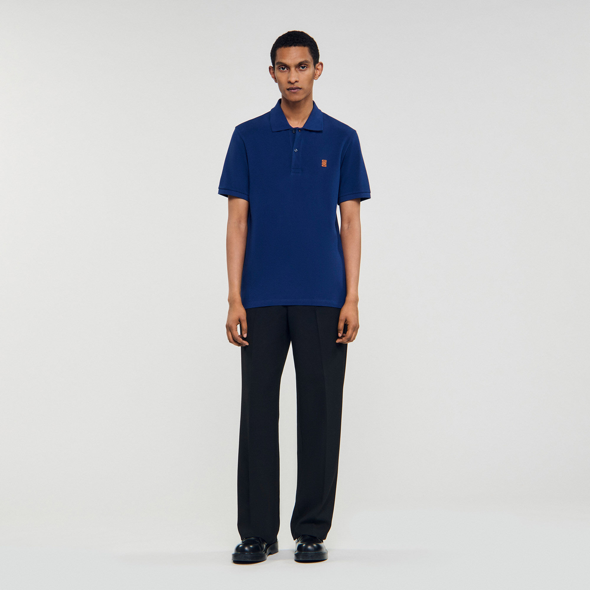 Polo shirt with leather logo